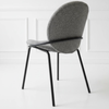Image of Silla Vila tapizada en tela boucle con patas de hierro negro.