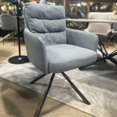 Sillón Doha giratorio tapizado en tela con patas de hierro negro.